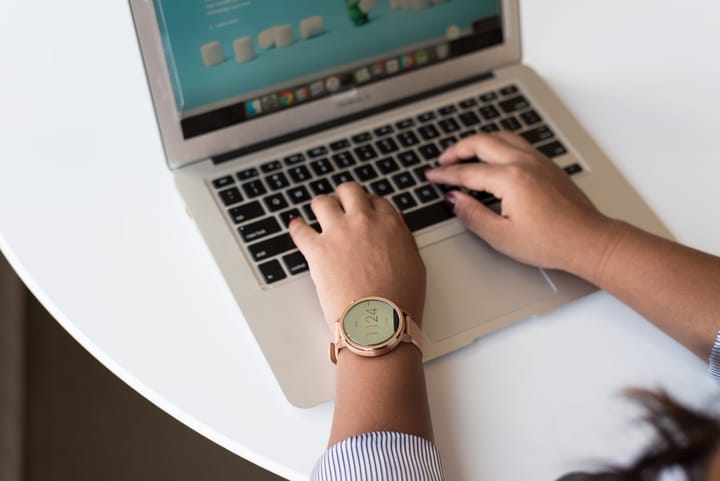 A woman on her laptop working on a website